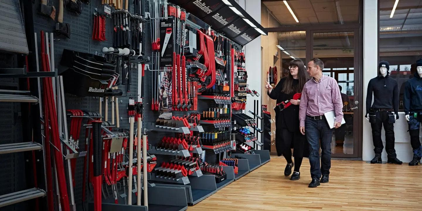 Two people looking at work tools