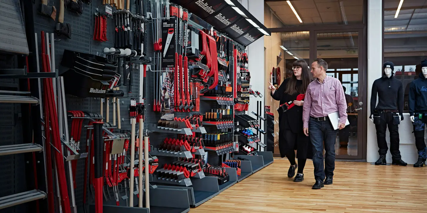 Two people looking at work tools